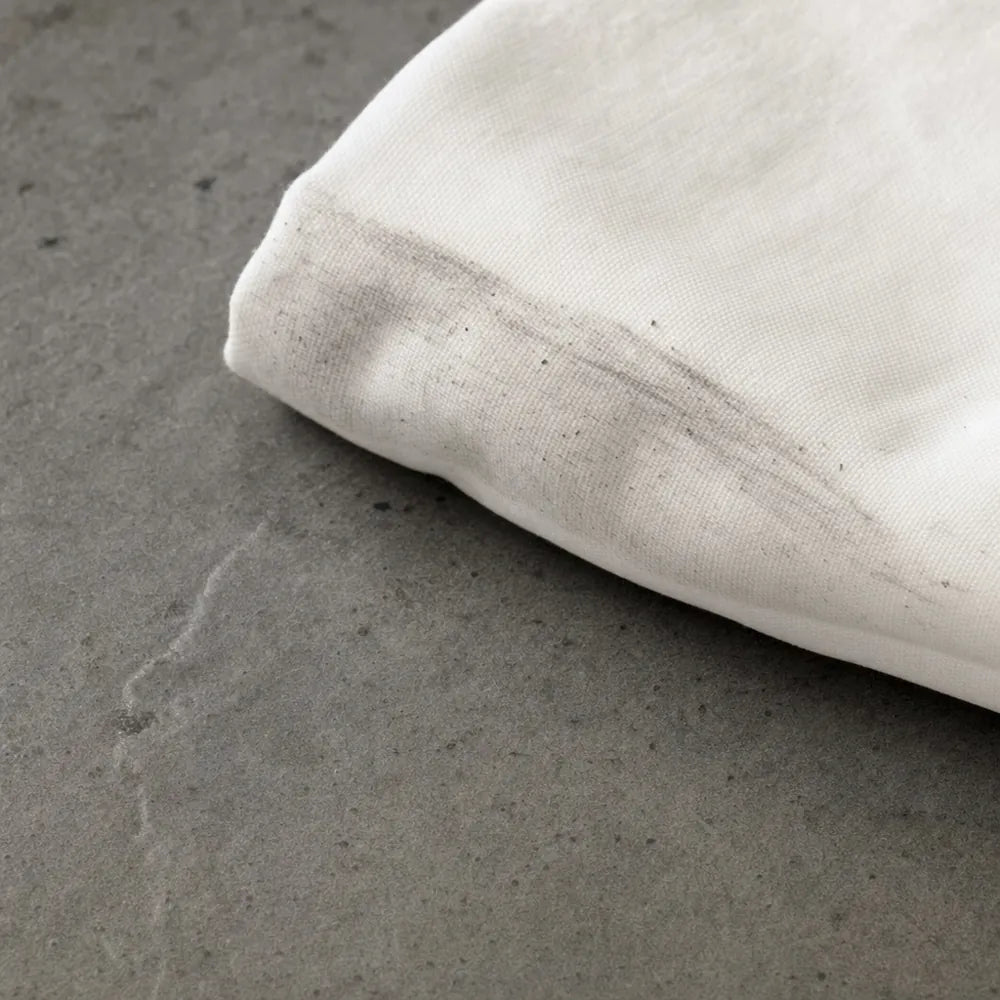 A grey cloth showing residue lifted from a counter cleaned the old way